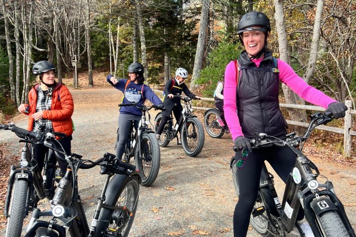 a group of people standing around a motorcycle