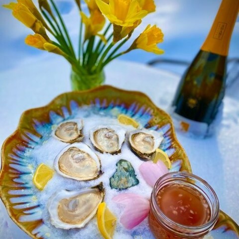 a plate topped with a vase of flowers on a table