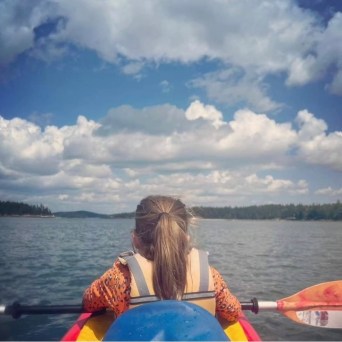 a person sitting in a boat on a body of water